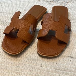 Tan color slide sandal. Reserved.